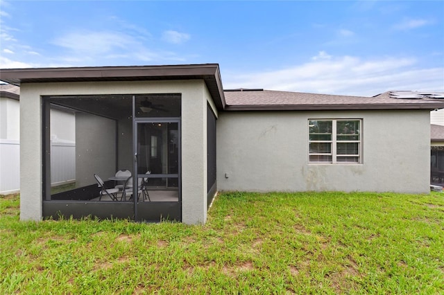 120 Citrus Isle St, Davenport, FL 33837 - rear view of property featuring a sunroom, stucco siding, and a yard