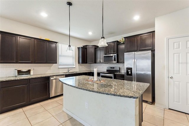 120 Citrus Isle St, Davenport, FL 33837 - kitchen featuring stainless steel appliances, decorative backsplash, dark brown cabinetry, stone countertops, and recessed lighting
