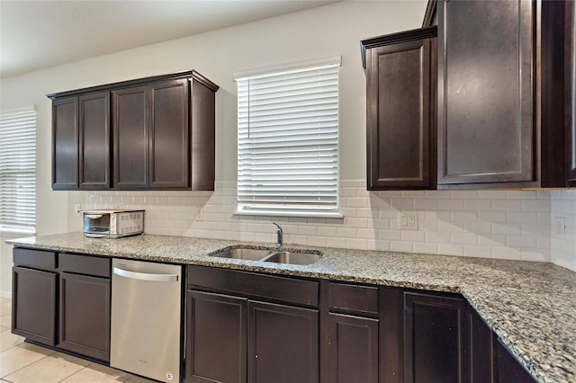 120 Citrus Isle St, Davenport, FL 33837 - kitchen featuring stainless steel dishwasher, dark brown cabinetry, decorative backsplash, light stone countertops, and light tile patterned floors