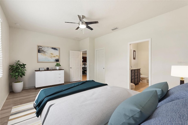 120 Citrus Isle St, Davenport, FL 33837 - bedroom featuring light wood-type flooring, ensuite bath, and a ceiling fan
