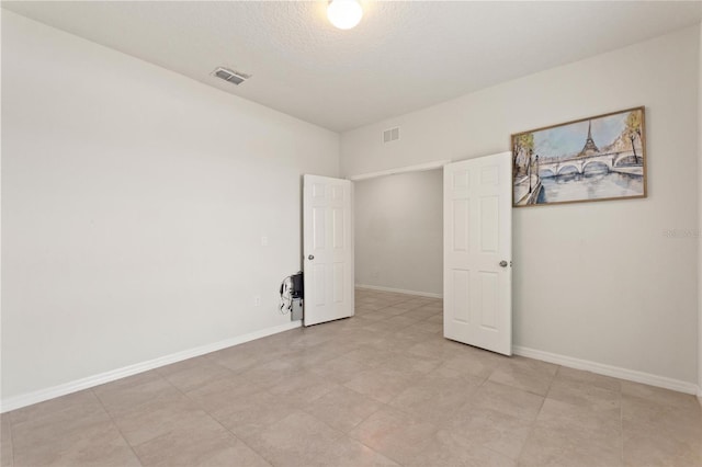 120 Citrus Isle St, Davenport, FL 33837 - unfurnished bedroom featuring baseboards and a textured ceiling