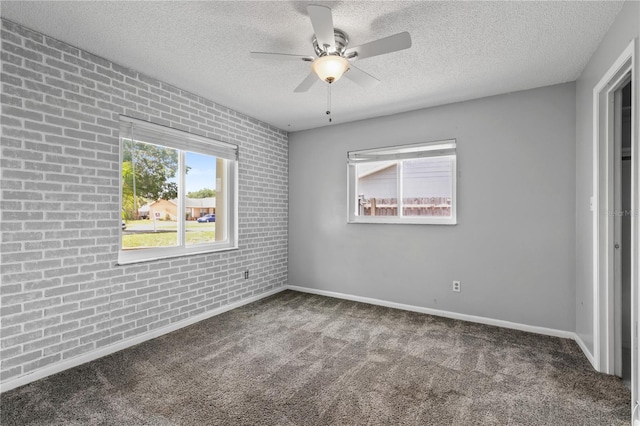 461 Kee St, Apopka, FL 32712 - unfurnished bedroom with a textured ceiling, carpet, a ceiling fan, and brick wall
