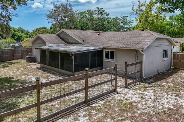 461 Kee St, Apopka, FL 32712 - back of house with a shingled roof, a sunroom, and a fenced backyard