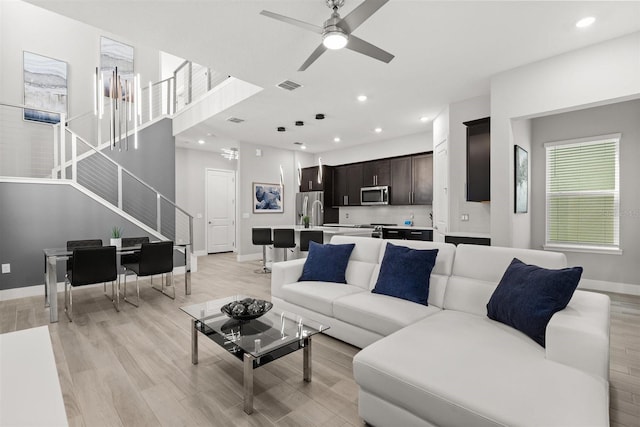 2163 White Feather Loop, Oakland, FL 34787 - living room with stairs, ceiling fan, light wood-style flooring, and recessed lighting