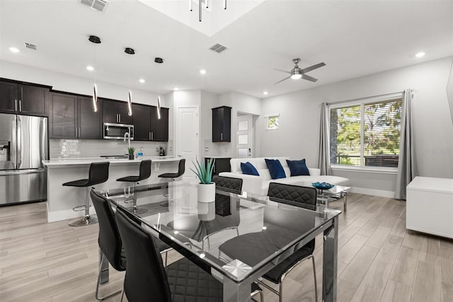 2163 White Feather Loop, Oakland, FL 34787 - dining room featuring a ceiling fan, light wood-style floors, and recessed lighting