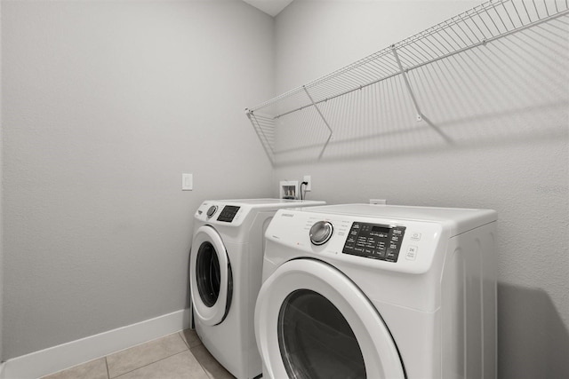2163 White Feather Loop, Oakland, FL 34787 - laundry area with washer and dryer and light tile patterned floors