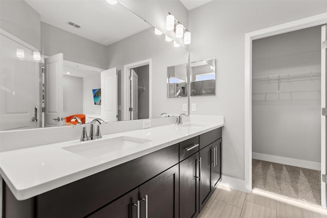 2163 White Feather Loop, Oakland, FL 34787 - bathroom featuring double vanity and a walk in closet