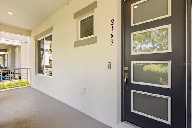 2163 White Feather Loop, Oakland, FL 34787 - view of exterior entry featuring stucco siding