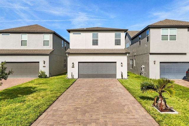 2163 White Feather Loop, Oakland, FL 34787 - traditional-style home with a garage, decorative driveway, a front yard, and stucco siding