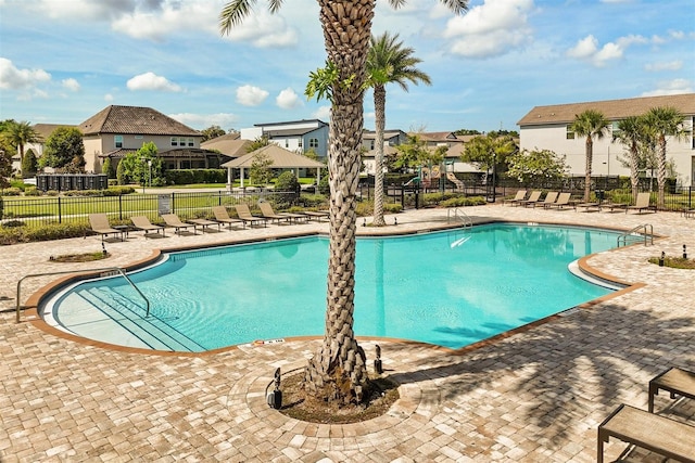 2163 White Feather Loop, Oakland, FL 34787 - community pool with a patio and a residential view