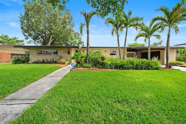 138 W 52nd St, Hialeah, FL 33012 - ranch-style home with stucco siding and a front yard