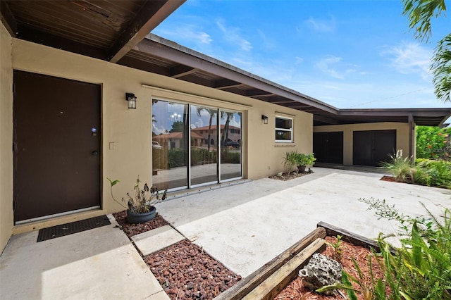 138 W 52nd St, Hialeah, FL 33012 - property entrance featuring a patio area and stucco siding