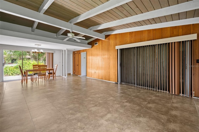 138 W 52nd St, Hialeah, FL 33012 - unfurnished living room featuring wooden walls, a chandelier, and ceiling fan