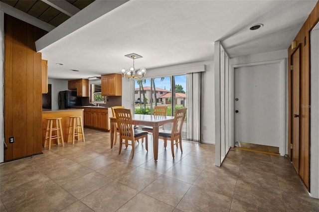 138 W 52nd St, Hialeah, FL 33012 - dining area featuring a chandelier
