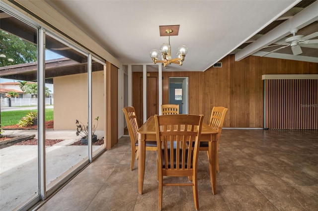 138 W 52nd St, Hialeah, FL 33012 - dining room featuring wooden walls, a chandelier, and a ceiling fan