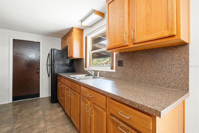 138 W 52nd St, Hialeah, FL 33012 - kitchen featuring freestanding refrigerator, tasteful backsplash, and brown cabinets