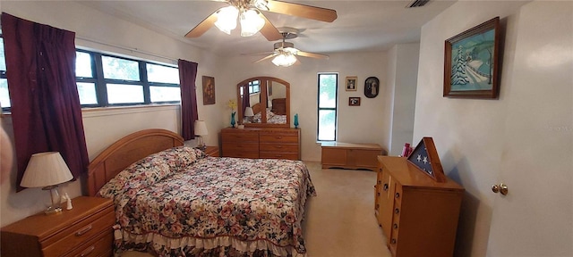 13420 Debbie Ln, Clermont, FL 34715 - bedroom with light colored carpet, multiple windows, a ceiling fan, and arched walkways