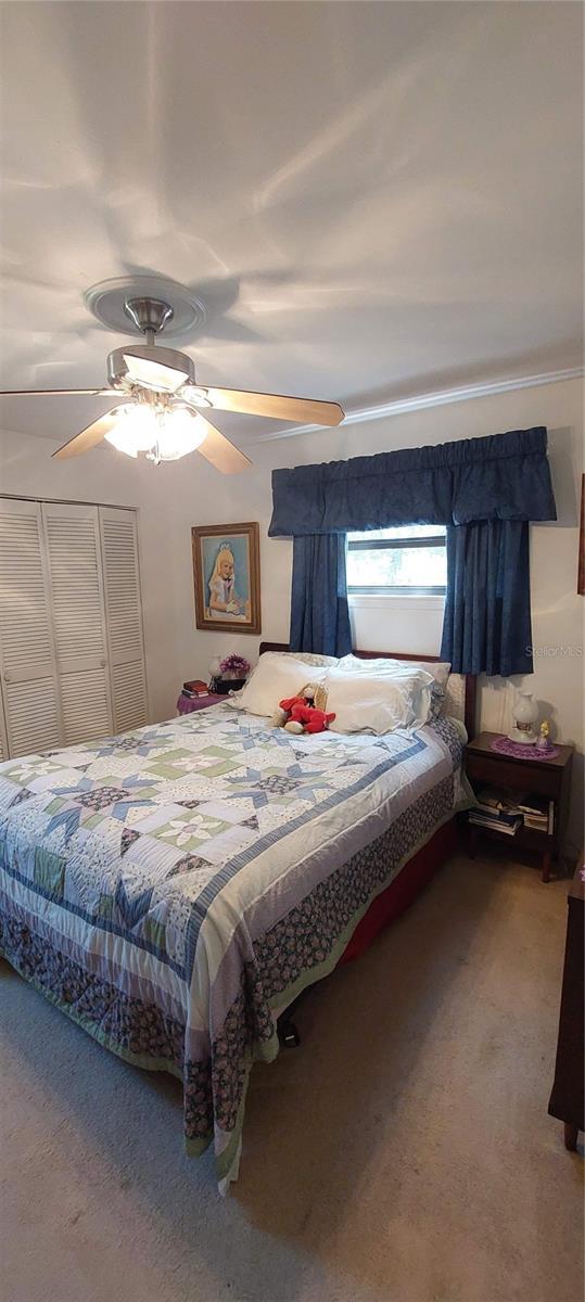 13420 Debbie Ln, Clermont, FL 34715 - bedroom with carpet flooring and ceiling fan