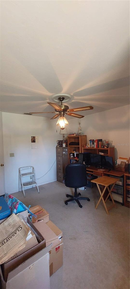 13420 Debbie Ln, Clermont, FL 34715 - carpeted office with a ceiling fan
