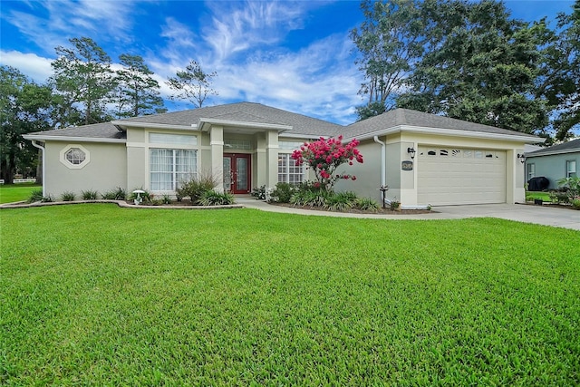 5349 Grove Mnr, Lady Lake, FL 32159 - view of front of property featuring french doors, stucco siding, an attached garage, and concrete driveway