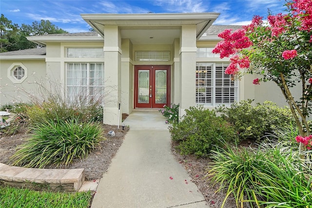 5349 Grove Mnr, Lady Lake, FL 32159 - property entrance featuring stucco siding, french doors, and a shingled roof