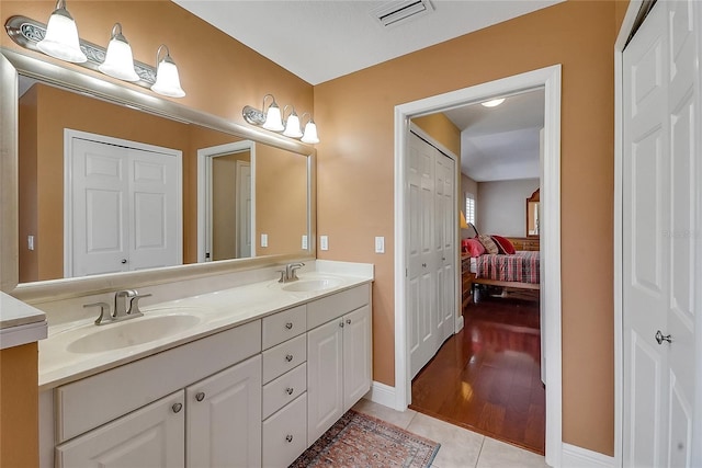 5349 Grove Mnr, Lady Lake, FL 32159 - full bathroom featuring double vanity, tile patterned flooring, and connected bathroom