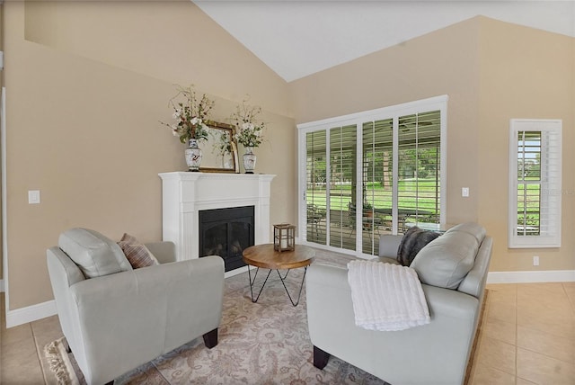 5349 Grove Mnr, Lady Lake, FL 32159 - living area featuring healthy amount of natural light, lofted ceiling, light tile patterned flooring, and a glass covered fireplace