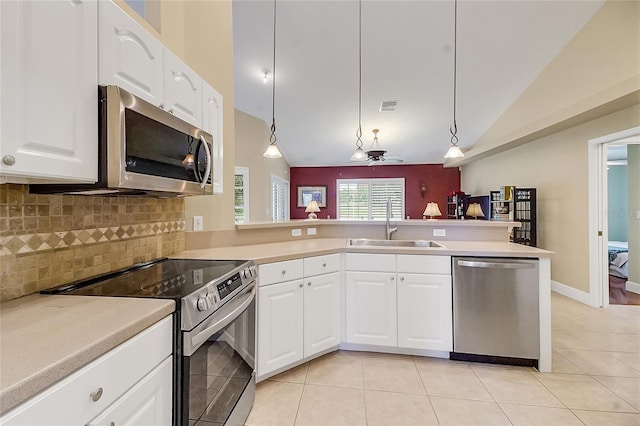 5349 Grove Mnr, Lady Lake, FL 32159 - kitchen with stainless steel appliances, backsplash, light tile patterned flooring, hanging light fixtures, and light countertops