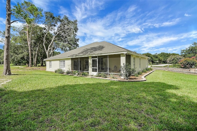 5349 Grove Mnr, Lady Lake, FL 32159 - back of house with a yard, a sunroom, and stucco siding
