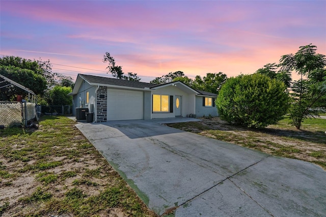 11326 Yellowwood Ln, Port Richey, FL 34668 - ranch-style house featuring a garage, driveway, and stucco siding