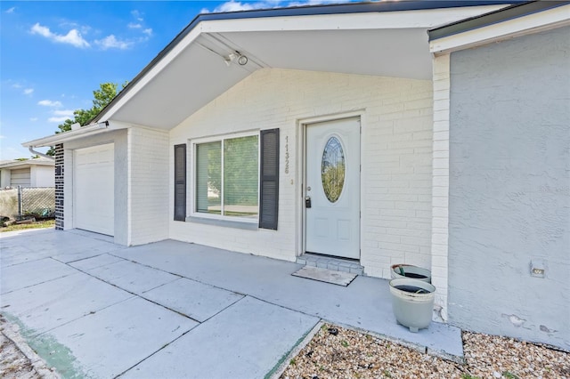 11326 Yellowwood Ln, Port Richey, FL 34668 - entrance to property with brick siding, an attached garage, and driveway