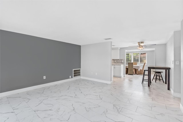 11326 Yellowwood Ln, Port Richey, FL 34668 - living room featuring light marble finish flooring and a ceiling fan