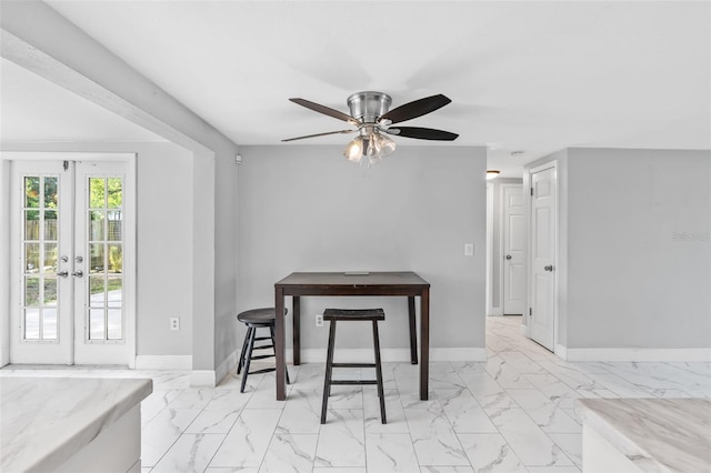 11326 Yellowwood Ln, Port Richey, FL 34668 - dining area with marble look tile flooring, ceiling fan, and french doors
