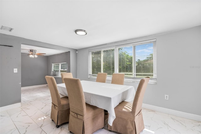 11326 Yellowwood Ln, Port Richey, FL 34668 - dining space featuring light marble finish flooring and a ceiling fan