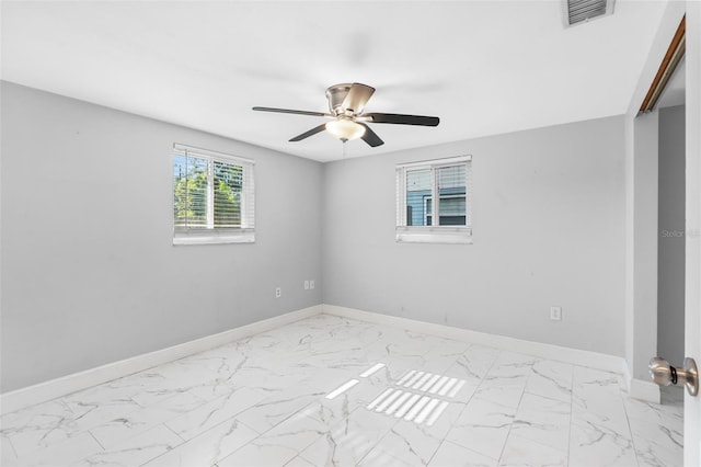 11326 Yellowwood Ln, Port Richey, FL 34668 - unfurnished room with marble finish flooring and a ceiling fan