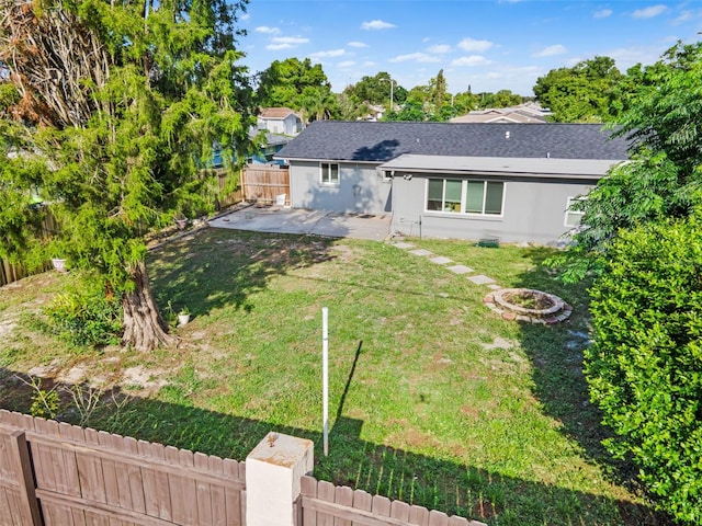 11326 Yellowwood Ln, Port Richey, FL 34668 - fenced yard featuring a patio area and an outdoor fire pit