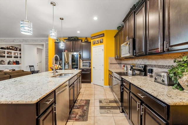 30300 Hackney Loop, Mount Dora, FL 32757 - kitchen featuring appliances with stainless steel finishes, dark brown cabinetry, tasteful backsplash, light tile patterned floors, and light stone countertops