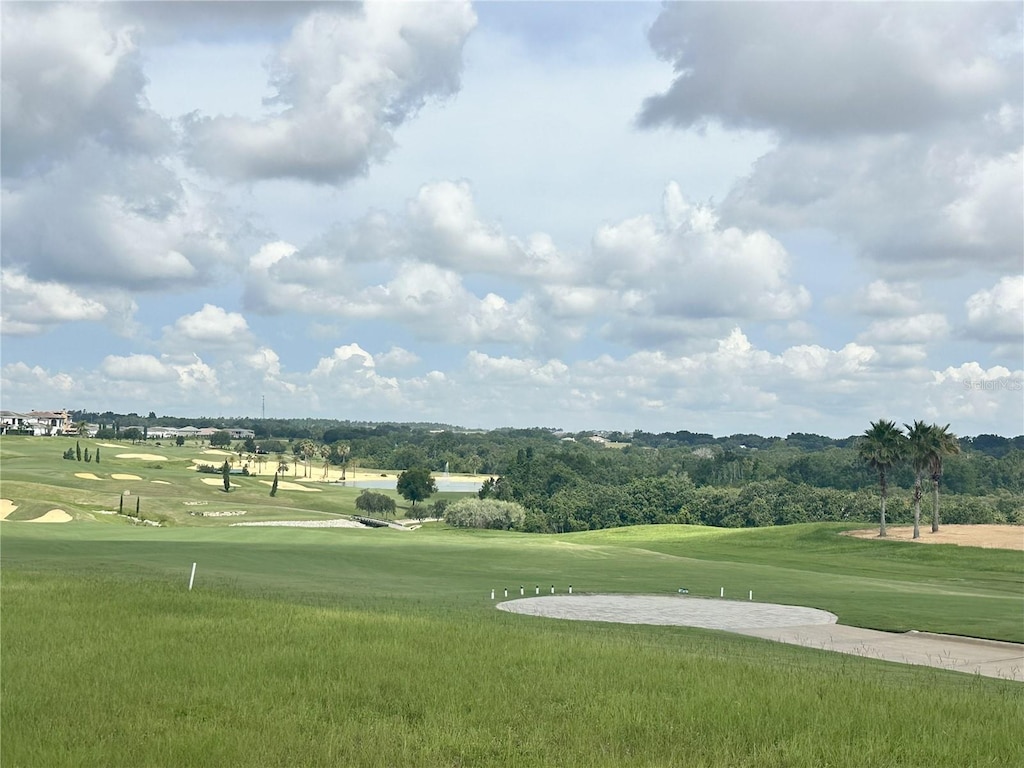 view of community featuring golf course view and a yard