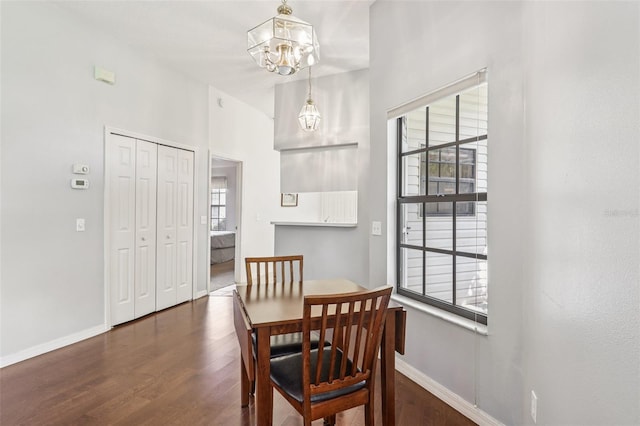 324 Juniper Way, Tavares, FL 32778 - dining area with wood finished floors, healthy amount of natural light, a chandelier, and a high ceiling