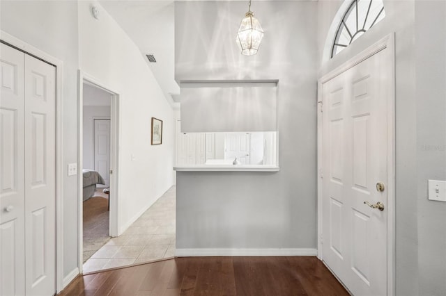 324 Juniper Way, Tavares, FL 32778 - foyer with a chandelier, wood finished floors, and a high ceiling