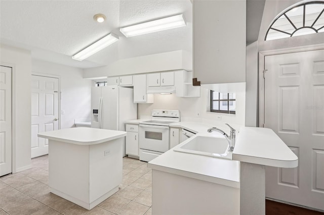 324 Juniper Way, Tavares, FL 32778 - kitchen with white appliances, light countertops, a peninsula, a textured ceiling, and under cabinet range hood