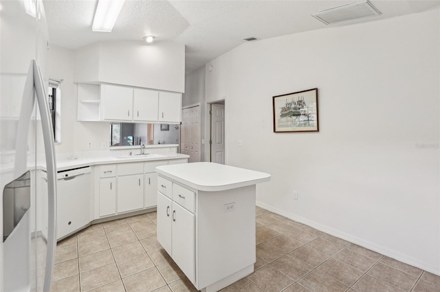 324 Juniper Way, Tavares, FL 32778 - kitchen with dishwasher, a center island, open shelves, light tile patterned floors, and light countertops