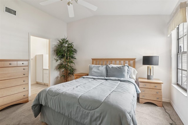 324 Juniper Way, Tavares, FL 32778 - bedroom featuring light carpet, multiple windows, lofted ceiling, a ceiling fan, and connected bathroom