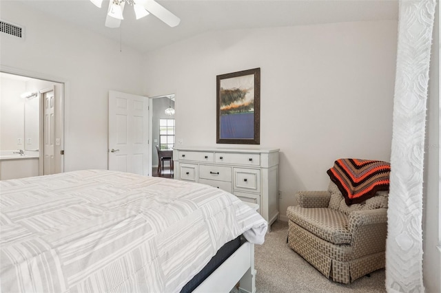 324 Juniper Way, Tavares, FL 32778 - bedroom with lofted ceiling, light carpet, connected bathroom, and a ceiling fan