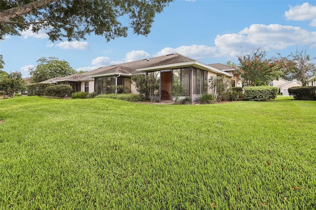 324 Juniper Way, Tavares, FL 32778 - back of house with a sunroom and a yard
