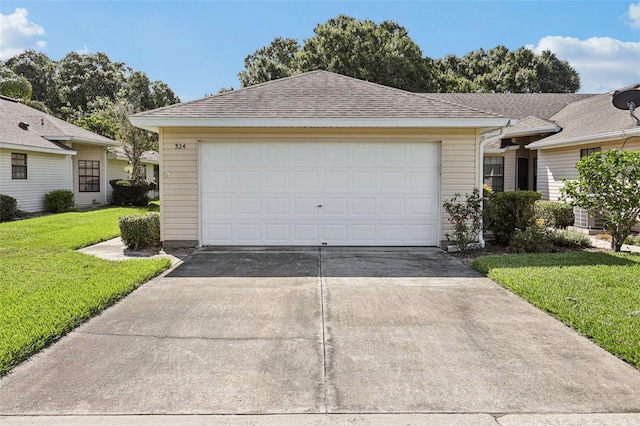 324 Juniper Way, Tavares, FL 32778 - view of front of home with driveway, a front yard, a shingled roof, and an attached garage
