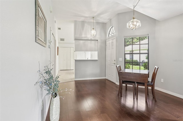 324 Juniper Way, Tavares, FL 32778 - dining room featuring a chandelier, hardwood / wood-style flooring, and a high ceiling