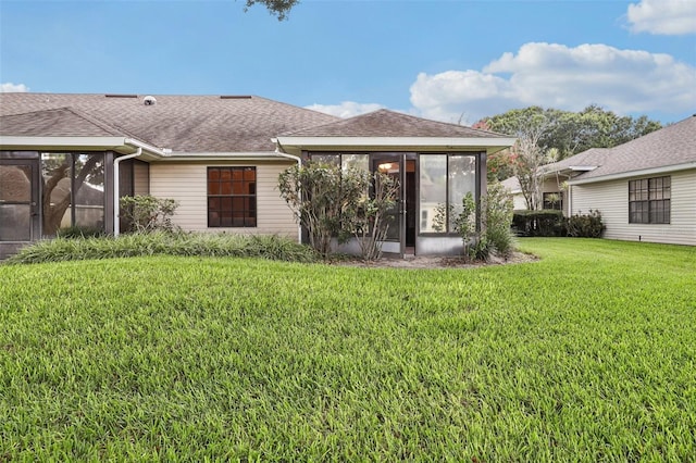 324 Juniper Way, Tavares, FL 32778 - back of house with a sunroom, a shingled roof, and a lawn