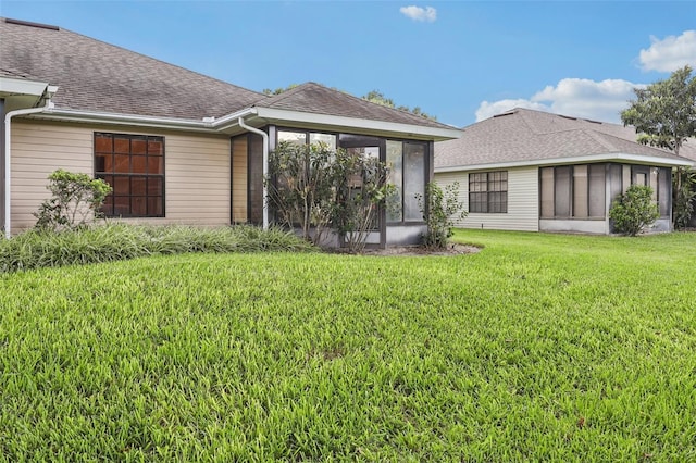 324 Juniper Way, Tavares, FL 32778 - back of property featuring a sunroom, a yard, and a shingled roof
