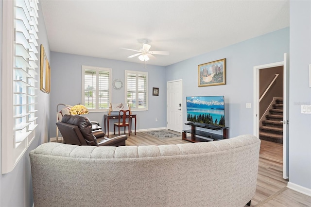 49 White Horse Way, Groveland, FL 34736 - living area featuring ceiling fan, light wood finished floors, and stairs